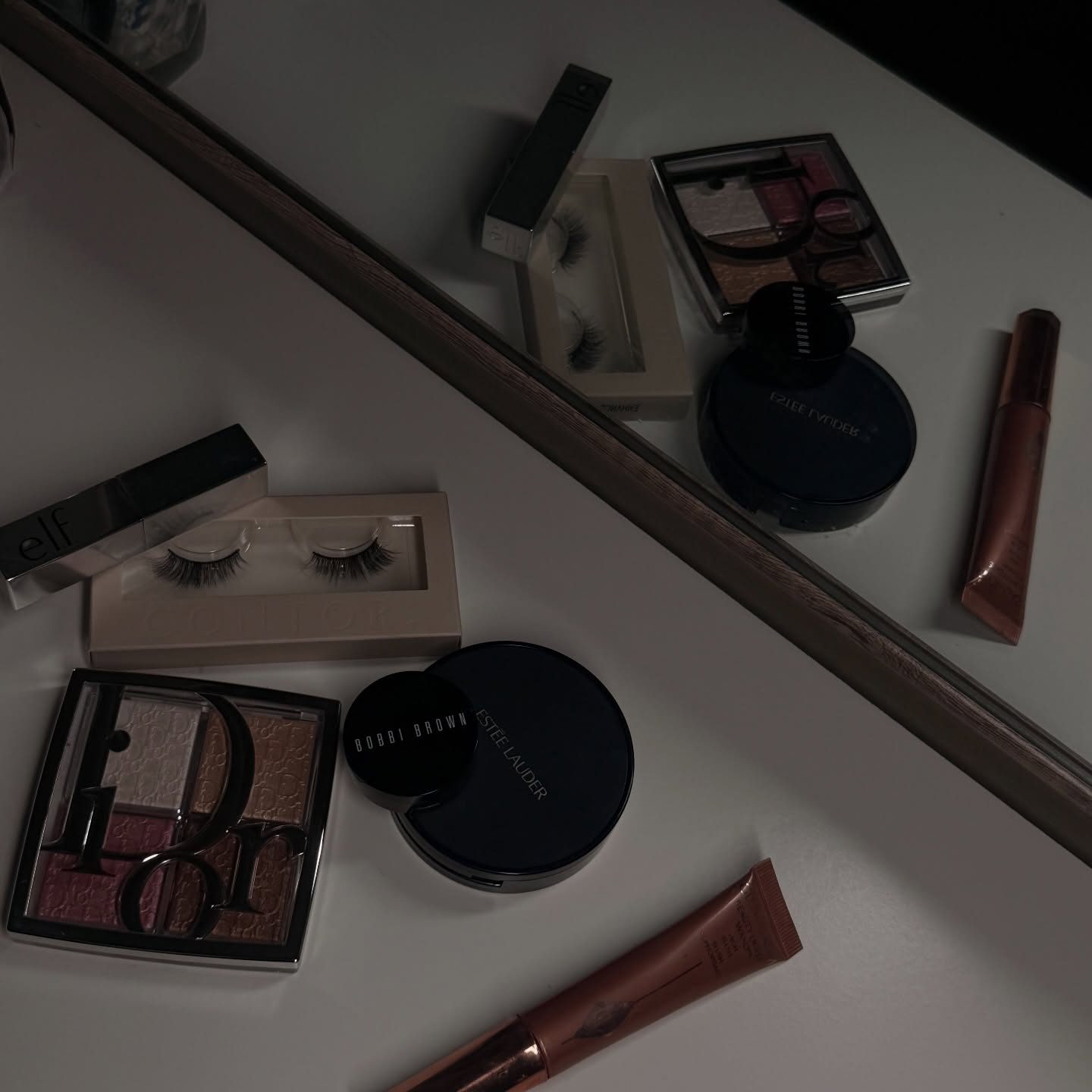 Makeup kit and lashes laid out in the studio